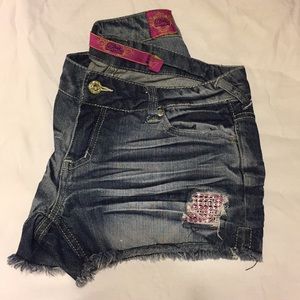 Distressed gem cutoff shorts